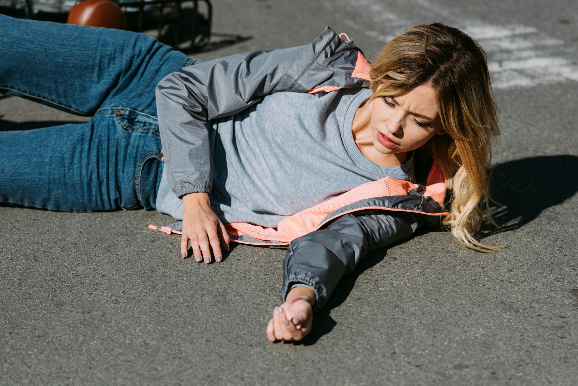 young woman mowed down by car on road, car accident concept