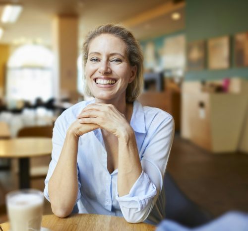 Portrait of happy woman in a cafe